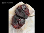 Fiery Spessartine Garnet crystals with Apatite on white Feldspar matrix.