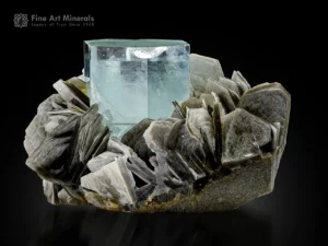 Pale blue aquamarine crystal with flat termination associated with muscovite blades from Pakistan.