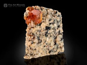 Lustrous orange bastnäsite crystals on contrasting natural matrix from Zagi Mountain.