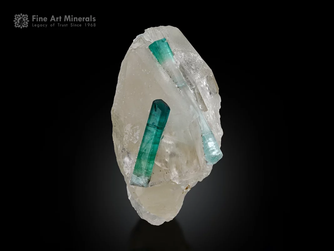 Bluish-green tourmaline crystals associated with quartz showing attractive color contrast and natural crystal growth