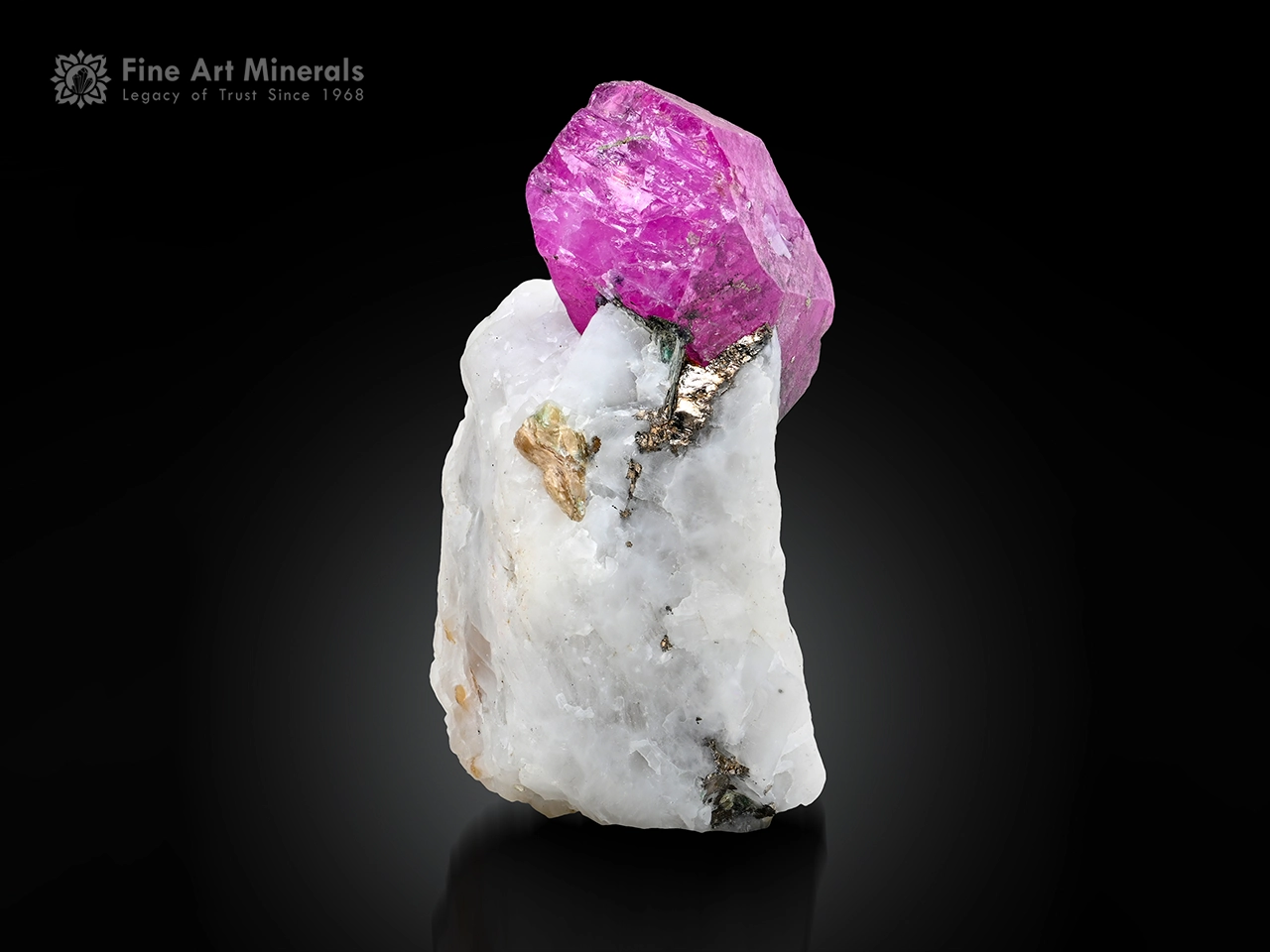 Vivid pink corundum var. ruby crystal on white matrix with pyrite from Afghanistan showing excellent color contrast.