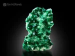 Emerald-green dioptase crystals covering a white matrix from Tsumeb, Namibia.