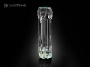 Transparent aquamarine crystal with etched formations, flat termination, and pristine rehealed base.