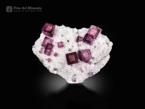 Sharp cubic fluorite crystals with phantom zoning and pyrite on a sparkling matrix.