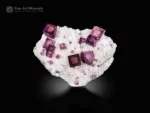 Sharp cubic fluorite crystals with phantom zoning and pyrite on a sparkling matrix.