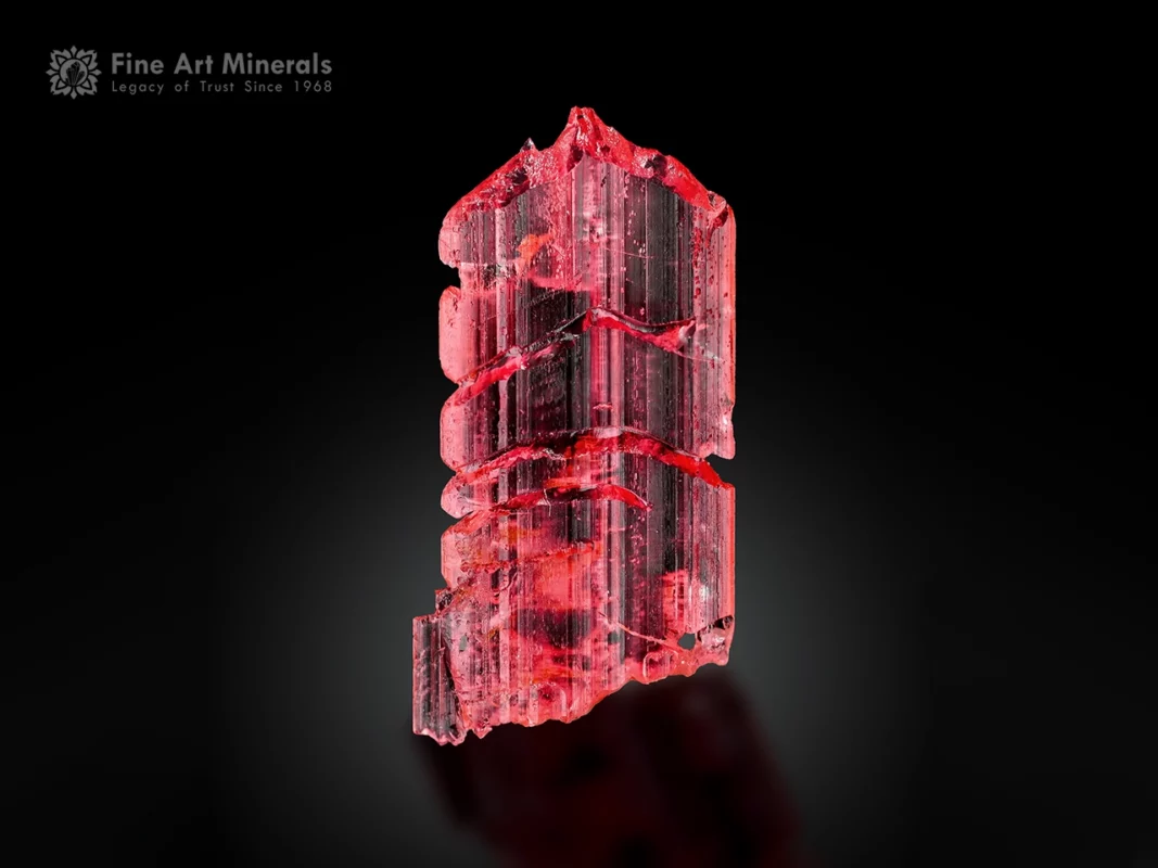 Elongated raspberry-red vayrynenite crystal with etched form and superb gem quality from Pakistan
