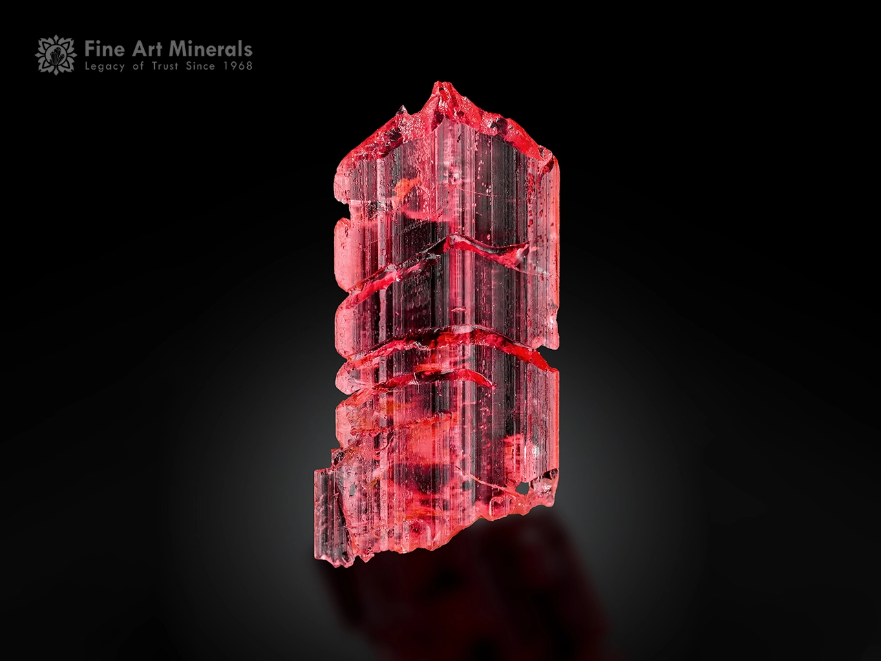Elongated raspberry-red vayrynenite crystal with etched form and superb gem quality from Pakistan