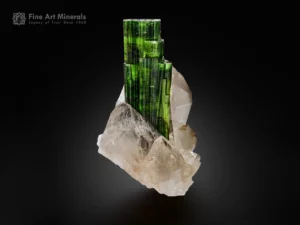 Green tourmaline crystal with flat termination growing on quartz matrix.