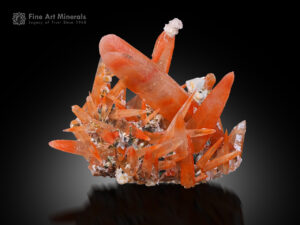 Vibrant orange quartz crystal cluster from Guangdong, China, with sharp elongated crystals.