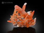 Vibrant orange quartz crystal cluster from Guangdong, China, with sharp elongated crystals.