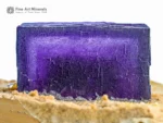 Deep purple Fluorite cube with sharp geometry on contrasting hard matrix.