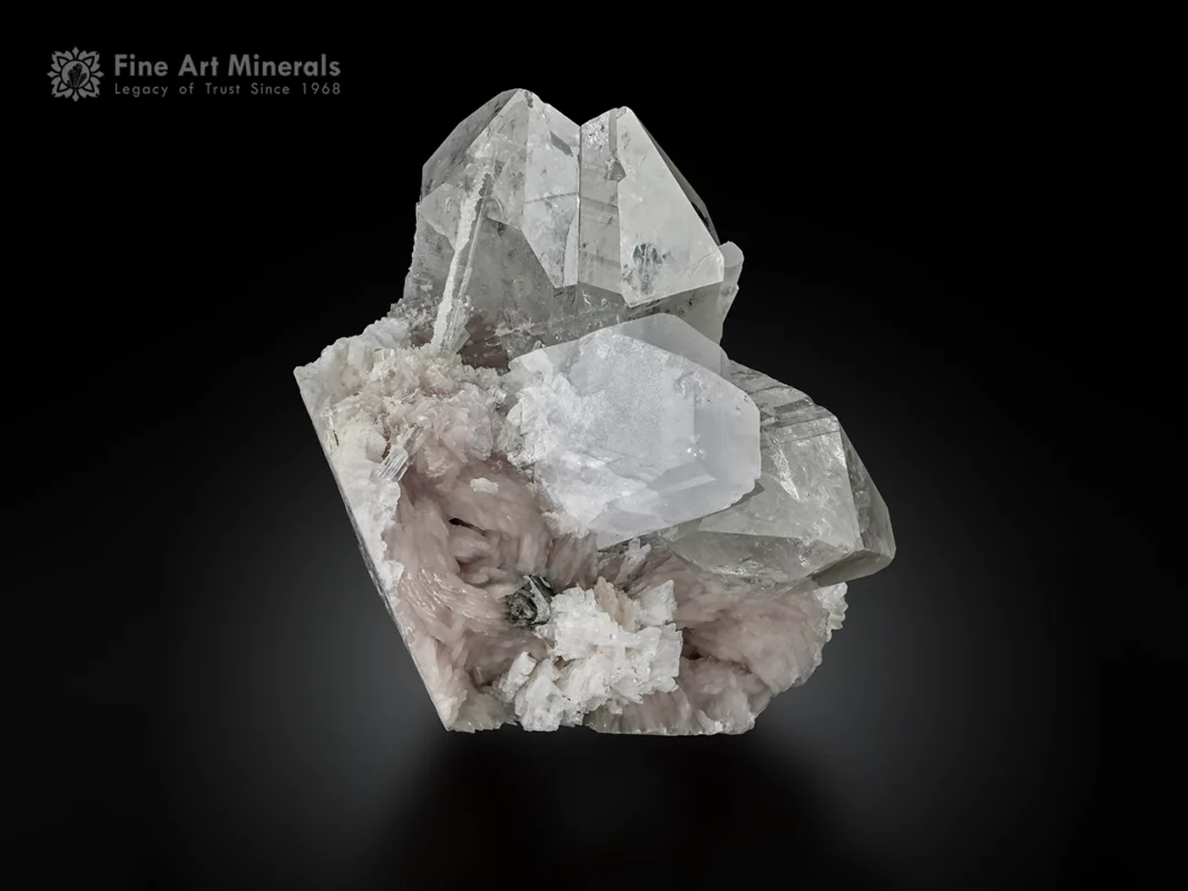 Quartz crystals with twinned viitaniemiite on pink lepidolite matrix.