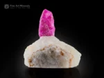 3 cm ruby crystal on white calcite matrix displaying strong orange fluorescence under UV light