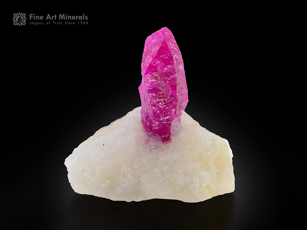 3 cm ruby crystal on white calcite matrix displaying strong orange fluorescence under UV light