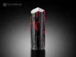 Elongated rutile crystal with fiery red internal glow from Zagi Mountain, Pakistan