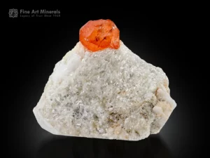 Orange spessartine garnet crystal perched on white matrix with excellent color and contrast.