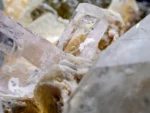 Lustrous Tantalite-(Mn) crystal associated with Quartz, Topaz, Albite, and Muscovite.