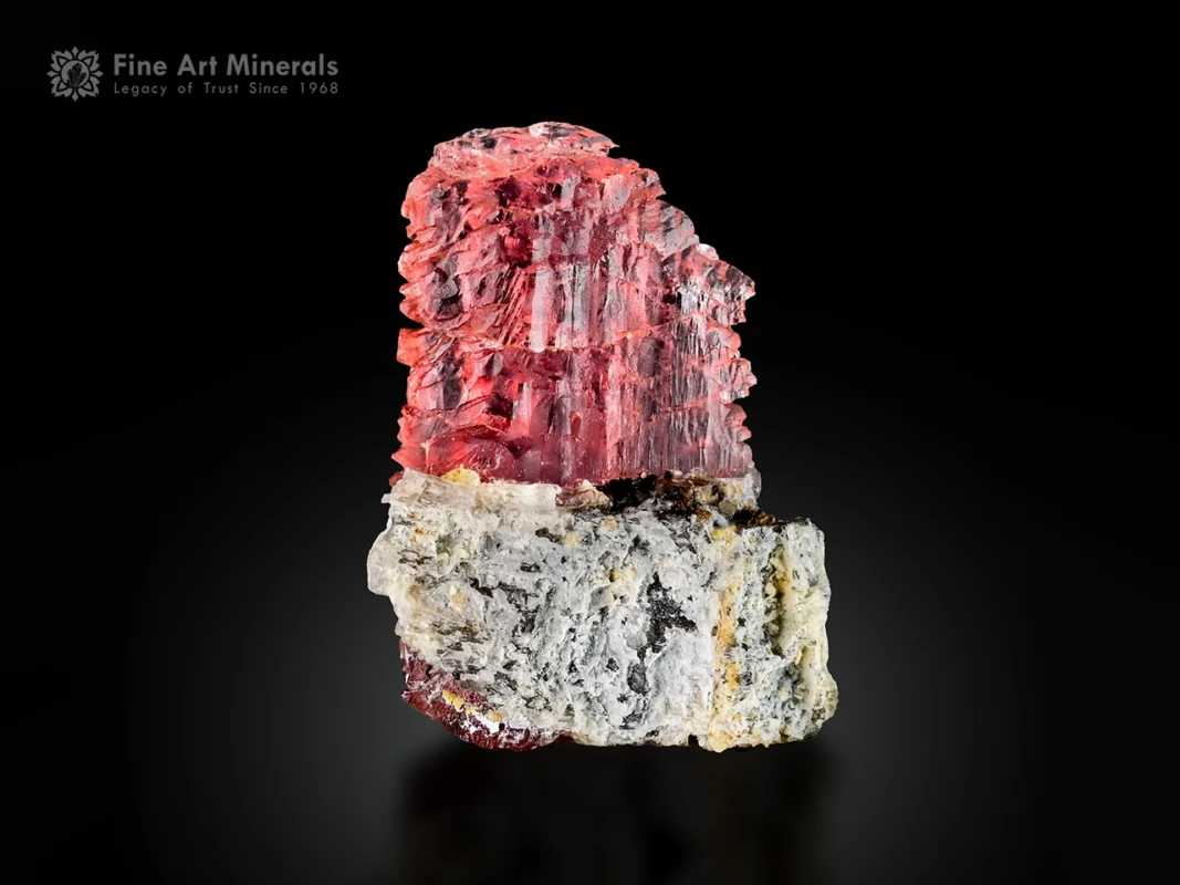Pinkish-red vayrynenite crystal with etched sugary texture on albite matrix from Shengus, Pakistan.