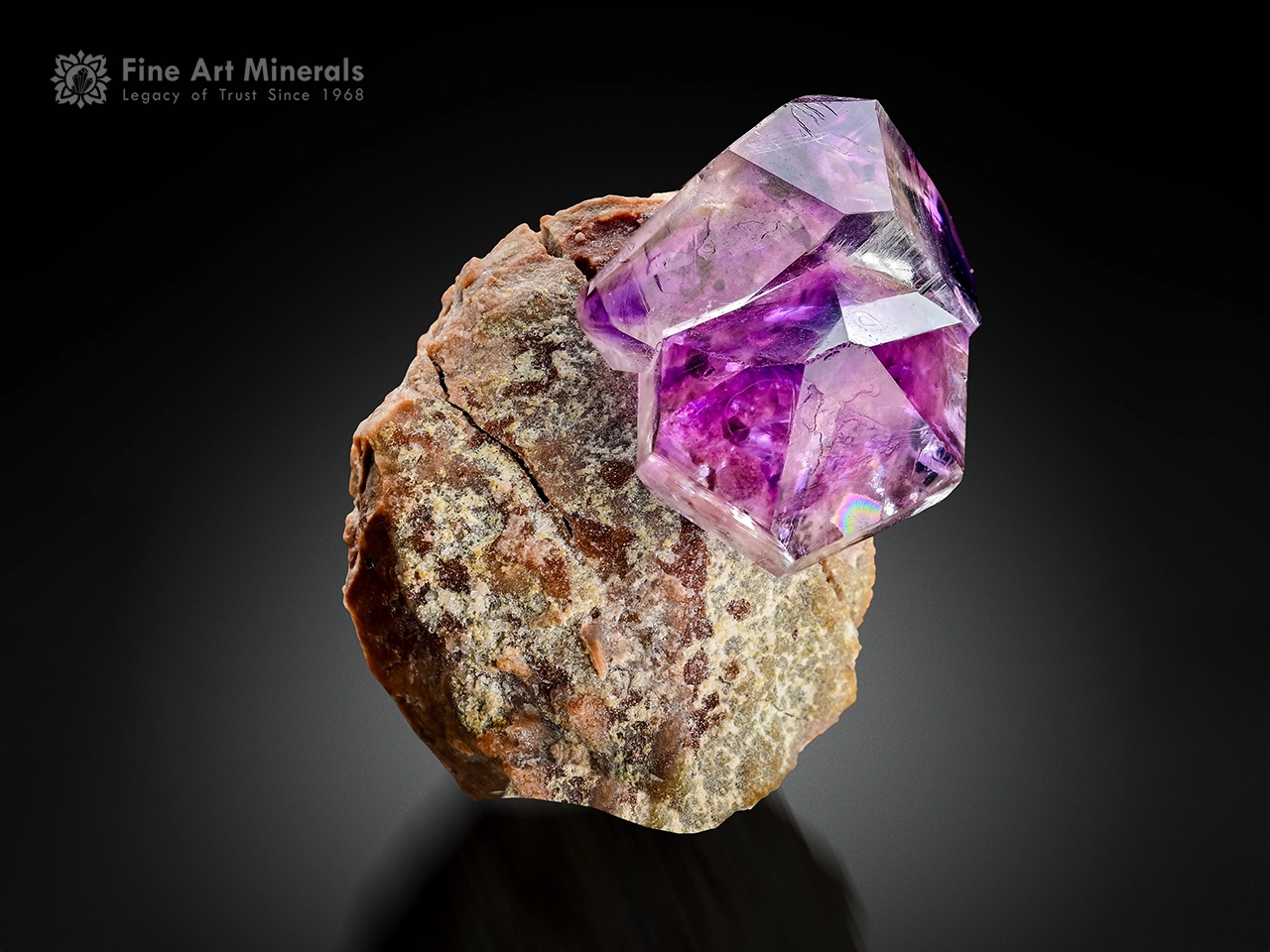 Gemmy purple amethyst crystal with a sharp, doubly terminated form on contrasting matrix from Goboboseb, Namibia.