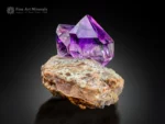 Gemmy purple amethyst crystal with a sharp, doubly terminated form on contrasting matrix from Goboboseb, Namibia.