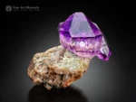 Gemmy purple amethyst crystal with a sharp, doubly terminated form on contrasting matrix from Goboboseb, Namibia.